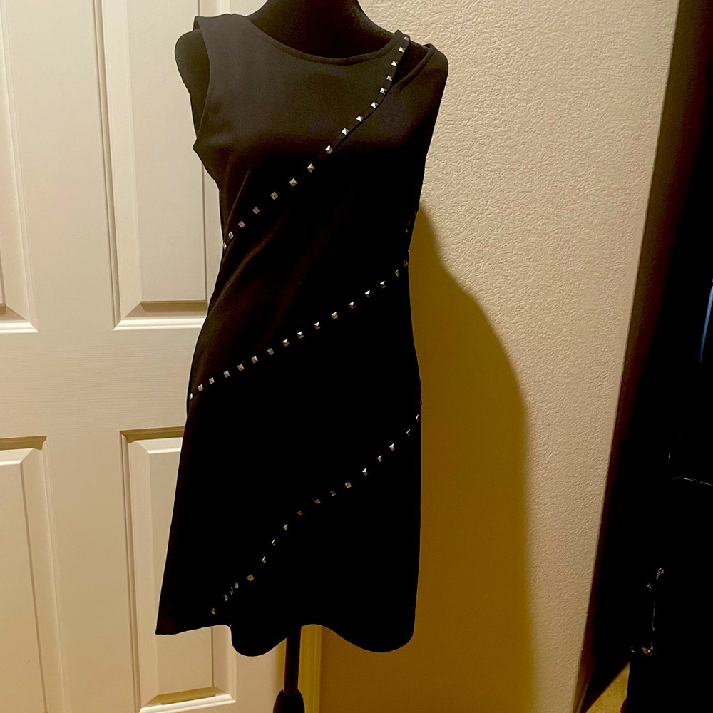 This is the perfect little black dress with silver grommets.